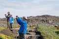 Tourists taking photos of waterfall Dettifoss in north Iceland