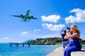 Tourists taking pictures in Corfu. Plane landing