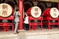 Tourists taking pictures on mobile phone on background of the Drums in the Bell Tower in Xian