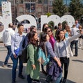 Tourists taking a selfie in front of the iAmsterdam sign at the