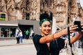 Tourists taking selfie in front of Sagrada Familia