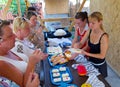 Tourists tasting Adygei cheese on the product presentation