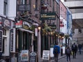 Tourists in Temple Bar, Dublin, Ireland with Irish pub and fish and chip shop