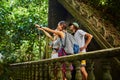 Tourists in thailand on top of ancient jungle ruins