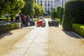 Tourists and their luggage having a reast at the historical Plaza de Oriente square in the centre of Madrid Spain Royalty Free Stock Photo