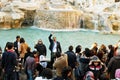 Tourists throwing coins in Fontana di Trevi, Rome