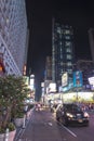 Tourists at Times Square at night, the famous location in New York city, full of people and cars and its neon light signs. Royalty Free Stock Photo