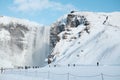 Tourists in to Iceland waterfall Skogafoss in Icelandic nature landscape view in winter season, The Skogafoss is one of the bigges Royalty Free Stock Photo