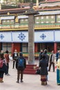 Tourists toss many coin to the top of stone pillar for lucky in the center of Rumtek Monastery in winter near Gangtok. Sikkim