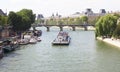 Tourists tour boat on Seine river.