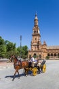 Tourists in a traditional horse carriage at the Plaza Espana in Sevilla Royalty Free Stock Photo