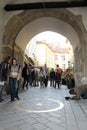 Tourists and tramp near center of Slovakia monument near Michael`s Gate on Michalska street