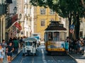 Tourists Travel By Historic Tram In Downtown Lisbon City