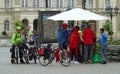 Tourists traveling on bicycles stop in Novi Sad, Serbia. Buying souvenirs and postcards