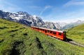 Tourists traveling on a cogwheel train of the famous Jungfrau Railway from Jungfraujoch Top of Europe Royalty Free Stock Photo