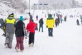 Tourists trudging through snow at a ski resort Royalty Free Stock Photo