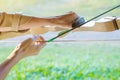 Tourists try to use a bow and arrow and shoot at a target Royalty Free Stock Photo