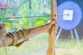 Tourists try to use a bow and arrow and shoot at a target Royalty Free Stock Photo