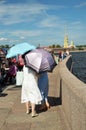 Tourists with umbrellas from the sunlight.