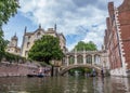 Tourists under Bridge of Sighs at Saint John`s College. Named for a famous Venice landmark, this circa-1831 covered arch bridge co