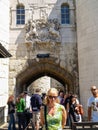 Tourists under the Middle Tower arch and crest