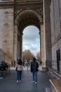 Tourists underneath the Arc de Triomphe on a spring morning in Paris, France Royalty Free Stock Photo