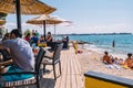 Tourists and various guests sitting at the bar by the sea and enjoy the sun in Zadar