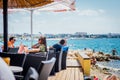 Tourists and various guests sitting at the bar by the sea and enjoy the sun in Zadar Royalty Free Stock Photo