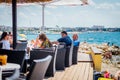 Tourists and various guests sitting at the bar by the sea and enjoy the sun in Zadar Royalty Free Stock Photo