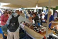 tourists of various nationalities shop in the characteristic market of typical products in Potamos, Greece