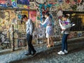 Tourists view Ghost Alley grafitti wall, Seattle, Washington