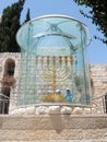 Tourists view and photograph Menorah - the golden seven-barrel lamp - the national and religious Jewish emblem near the Dung Gates