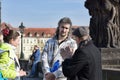 Tourists view Prague from Charles Bridge