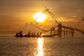 Tourists visit Chinese fish nets during sunrise