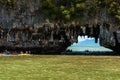 Tourists visit the limestone caves in the islands called Tham lo