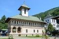 Tourists visit the old Lainici Monastery on a summer`s day, detail from the courtyard with exterior paintings