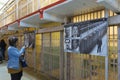 Tourists visiting Alcatraz prison and the main corridor with ordinary single cells on ground level. San Francisco historical landm