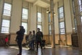 Tourists visiting Alcatraz prison and the main corridor with ordinary single cells on ground level. San Francisco historical landm