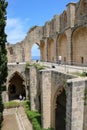 Tourists visiting Bellapais Abbey ruins in turkish Cyprus