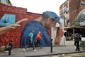 Tourists visiting Brick Lane street in East London , home of the graffiti artists Royalty Free Stock Photo