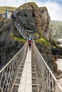 Tourists visiting Carrick-a-Rede Rope Bridge in County Antrim of Northern Ireland
