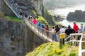 Tourists visiting Carrick-a-Rede Rope Bridge in County Antrim of Northern Ireland