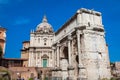 Tourists visiting the Church of Santi Luca e Martina and the Arch of Septimius Severus at the Roman