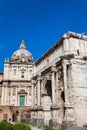 Tourists visiting the Church of Santi Luca e Martina and the Arch of Septimius Severus at the Roman