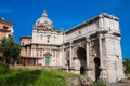 Tourists visiting the Church of Santi Luca e Martina and the Arch of Septimius Severus at the Roman