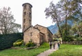 Tourists visiting EsglÃÂ©sia de Santa Coloma, Andorra`s oldest church, romanesque style, path leading towards the entrance