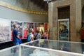Tourists are visiting exhibition about history of Kaiser Wilhelm Memorial Church in old part of temple, Berlin, Germany