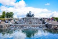 Tourists visiting Gefion Fountain, a group of animal figures being driven by the Norse goddess Gefjon, Copenhagen, Denmark