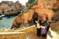 Tourists visiting the Natural features, cliffs and limestone formations of Ponta da Piedade