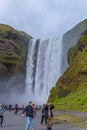 Tourists visiting Skogafoss waterfall